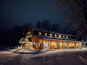 Snowy night landscape with brightly lit lodge at Minnesota lake resort