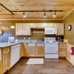 Fully equipped lakeside cabin kitchen with rustic accents