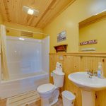 Full bathroom with tub on second floor of large family cabin rental