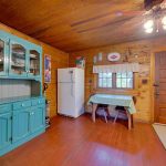 kitchen left side with vintage cabinetry and small dining table for 2-3
