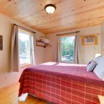 Second Floor Pine Bedroom with Quilt and Natural Light from Two Windows
