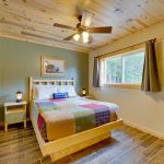 2br lake cabin rental bedroom with queen bed near window