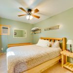 Spacious first floor tri level 4BR cabin's queen size bedroom. Features include air conditioner, ceiling fan, and tiled flooring that has in floor heat.