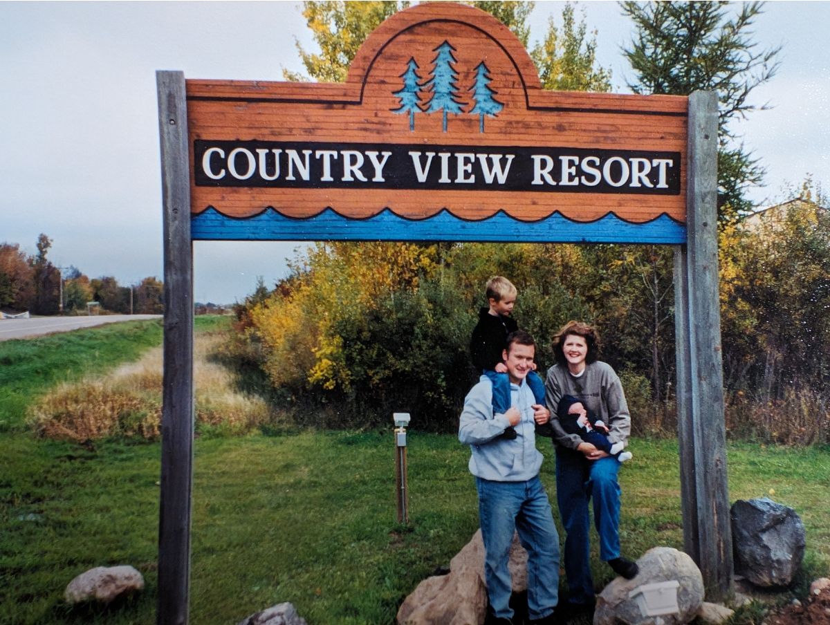 Our young family stands in front of the sign of the resort we just bought, a goal achieved on our roadmap to goal achievement