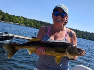From catching big walleye fish like this woman, to boat rentals, there is much to do on Fish Trap Lake