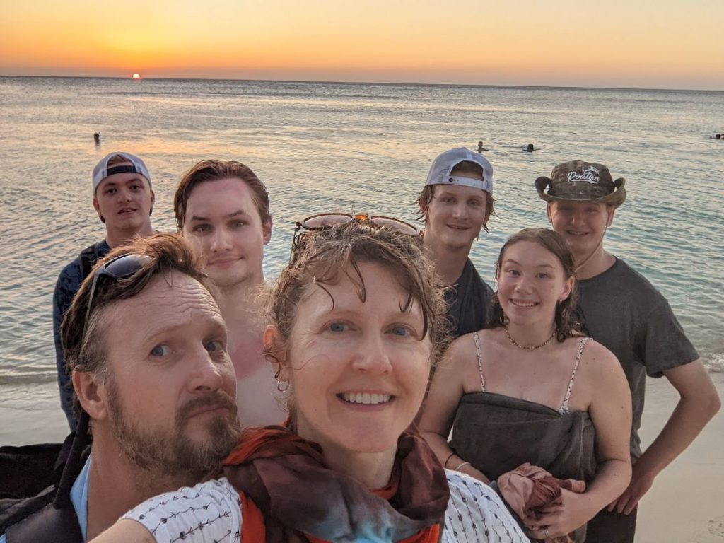 Stunning sunset view of a family and the Caribbean on the island of Roatan, Honduras.
