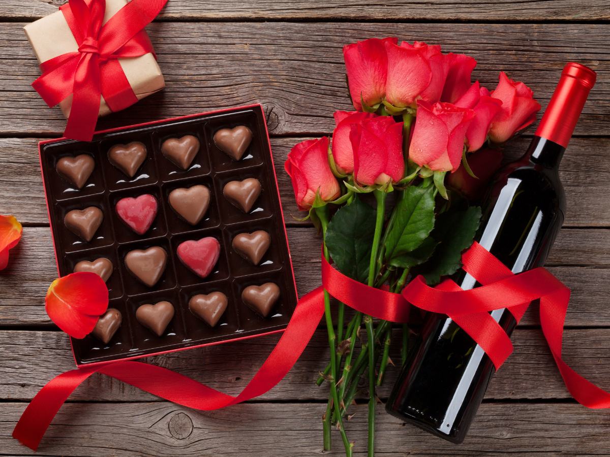 When you create the perfect romantic cabin getaway, include treats like this wine, chocolate, and roses, IF your partner likes them