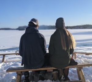Winter Activities in the Brainerd Lakes Area of Minnesota include sitting by a bonfire at a lake resort