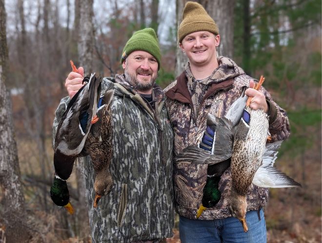 Father and son with 4 ducks after excellent duck hunting day near Campfire Bay Resort