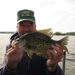 Man holding huge crappie caught on Fish Trap Lake