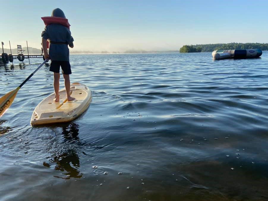The best month for a MN lake vacation is when you can paddle board and swim.