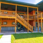 Exterior view of the front of the Aspen cabin at CBR. Shows entrance area and deck