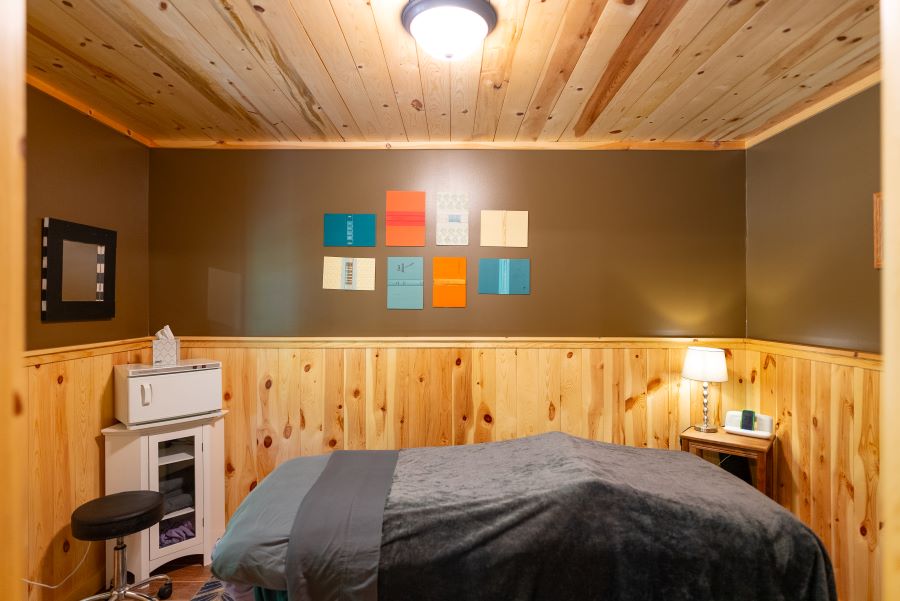 Cozy inviting massage table in wood accented room at up north MN resort