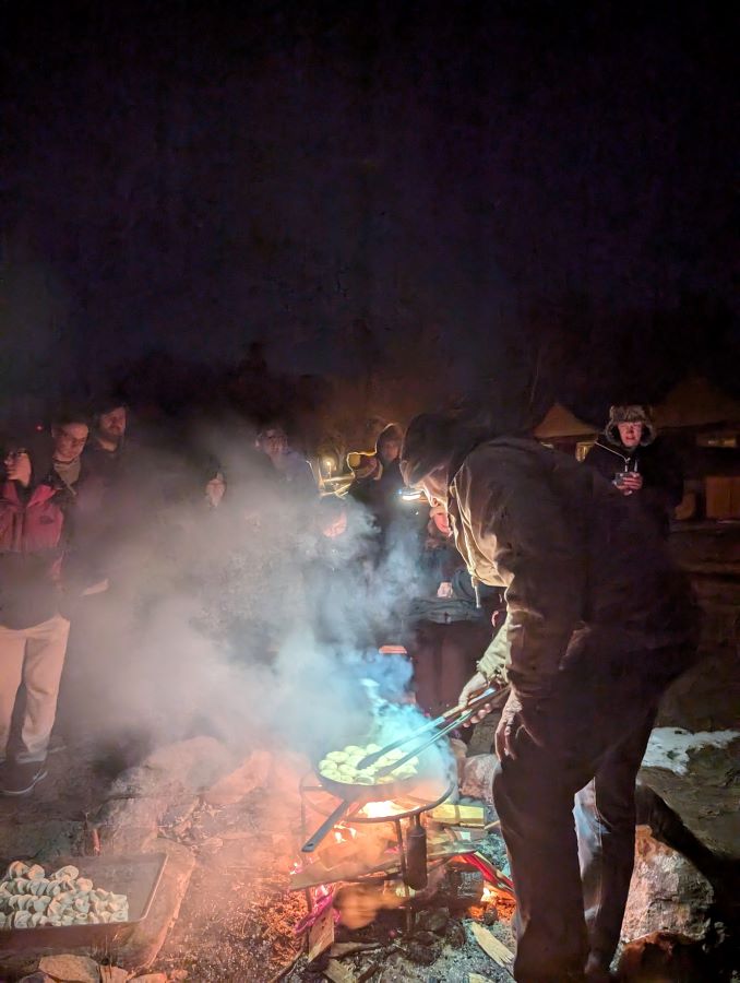 Making donuts over the fire in the dark using a head lamp on Fish Trap Lake