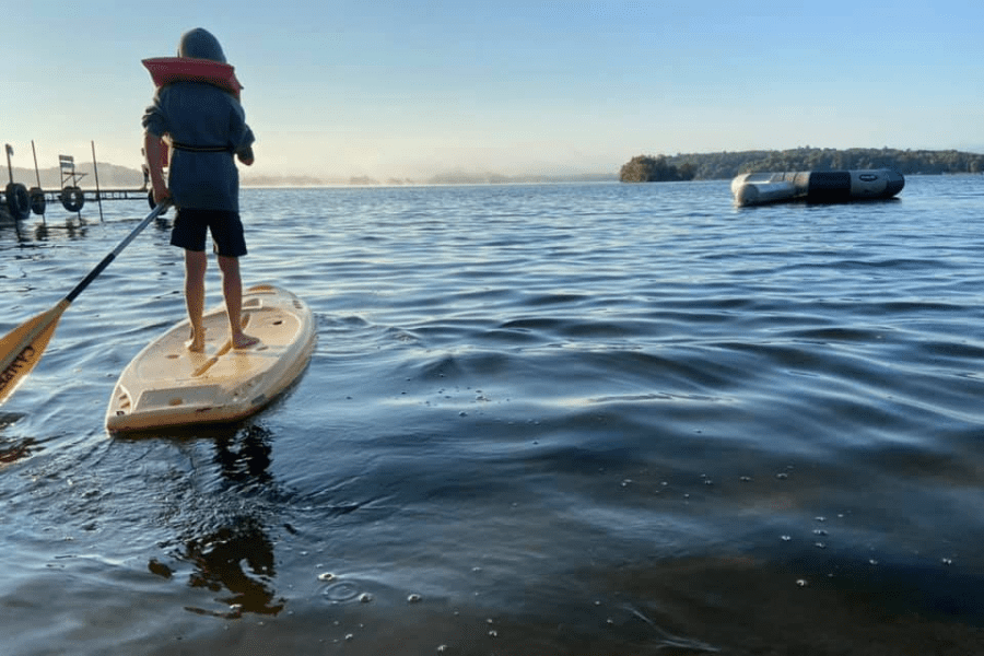 A boy on a paddle board.