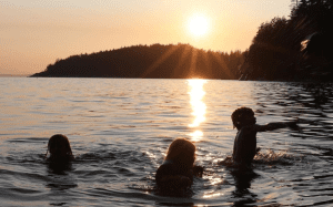 Swimming in the lake at sunset.