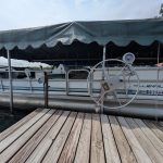 Side view of a Millennium Odyssey pontoon on a lift.