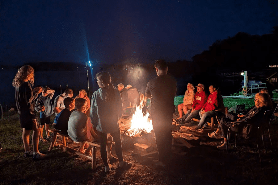 Guests bonding around a campfire at Campfire Bay Resort, creating lasting friendships.