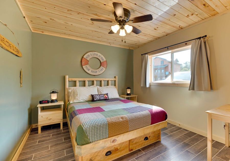 Lakeside cabin bedroom with pine ceiling, w